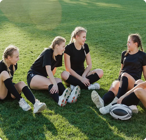 Coach reviewing notes while players train